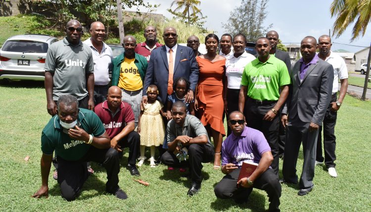 Prime Minister Dr the Hon Timothy Harris, and Deputy Speaker Senator the Hon Dr Bernicia Nisbett, pose for a group picture with members of the domino fraternity after the church service.
