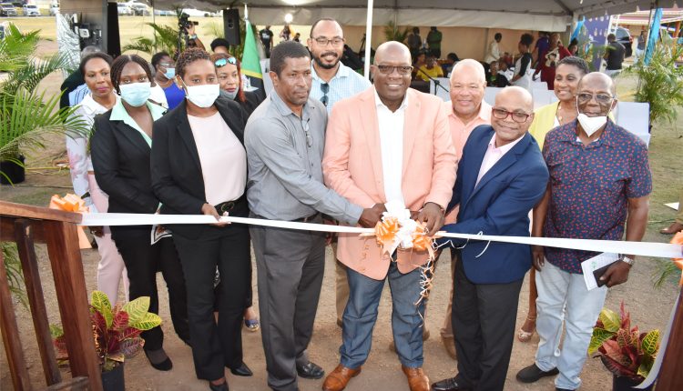 Prime Minister Dr the Hon Timothy Harris leads in the cutting of the ribbon to signify the official opening of the viewing decks at Black Rocks, in Bellevue.