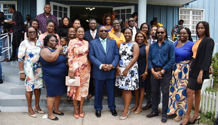 Prime Minister Harris and Minister Byron-Nisbett pose for a group picture after the service with members of the PLP National and Branch Executives.