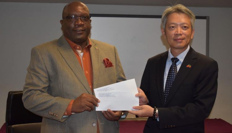 Resident Ambassador of the Republic of China (Taiwan) to the Federation of St. Kitts and Nevis, His Excellency Tom Lee presents cheques to Prime Minister Dr. the Hon. Timothy Harris.