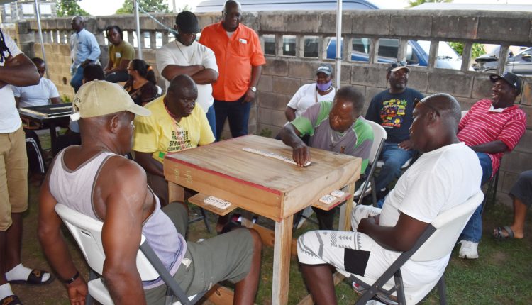 Sponsor of Number 7 Domino League, Prime Minister Dr the Hon Timothy Harris (standing right) watches as the O’Niel Thomas team battles the visiting Poor Man’s Pocket.