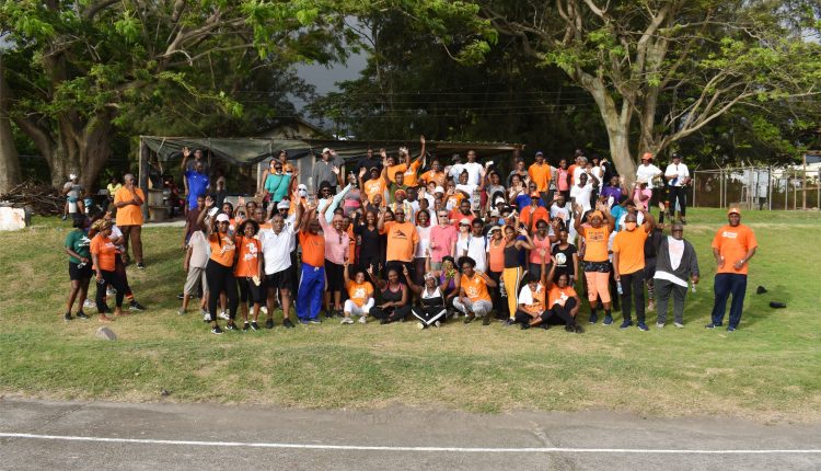 A subset of participants who took part in the Prime Minister’s Health Walk posing for a picture with Prime Minister Harris at the Ottley’s hard courts.
