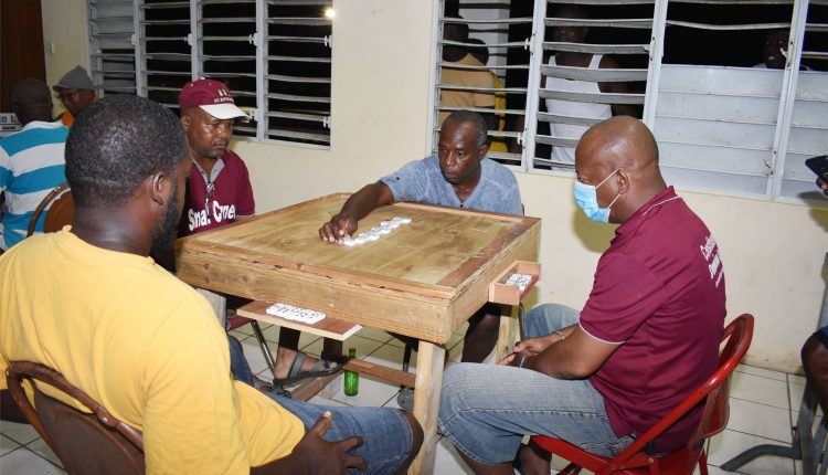 Former champions Lodge Domino Club’s Horatio Thomas takes no chances as his team marched on to beat Small Corner Bar Domino Club 13-6 at the Lodge Community Centre.