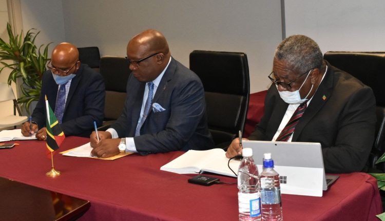 Government ministers Hon. Lindsay Grant (left), Prime Minister Dr. the Hon. Timothy Harris (center) and the Hon. Vincent Byron (right) take notes during Wednesday’s meeting with CIC officials.