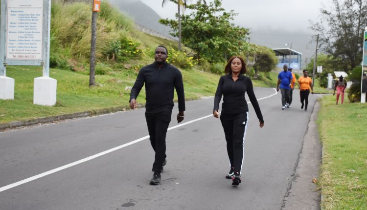 Minister of Health the Hon Akilah Byron-Nisbett accompanied by her husband Mr Alexis Nisbett as they walk past the Estridge Moravian Church in Mansion.