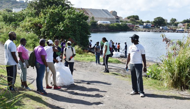 Mr Eavin Parry (right), Environment Scientist in the Department of Environment with other stakeholders as they collected garbage outside the fisheries complex.