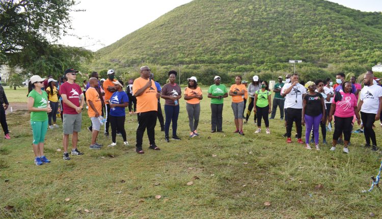 Prime Minister Dr the Hon Timothy Harris (holding the mike) at the Frigate Bay lawns addressing participants at the end SKN Moves anniversary Health Walk.