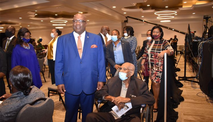 Prime Minister Dr the Hon Timothy Harris with Mr Richard Caines at the State opening of Parliament at the St. Kitts Marriott Resort. Behind the wheelchair is Mrs Avonice Thompson.
