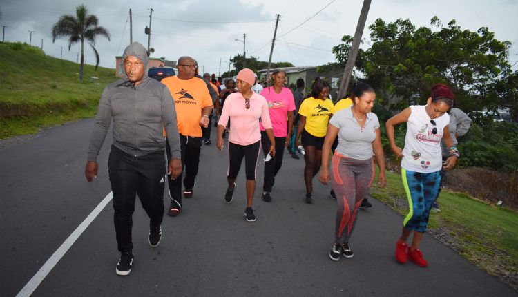 Prime Minister Harris, donning a SKN Moves T-shirt, at the start of the walk. He is seen canvasing with PLP’s National Secretary Ms Myrtilla Williams.