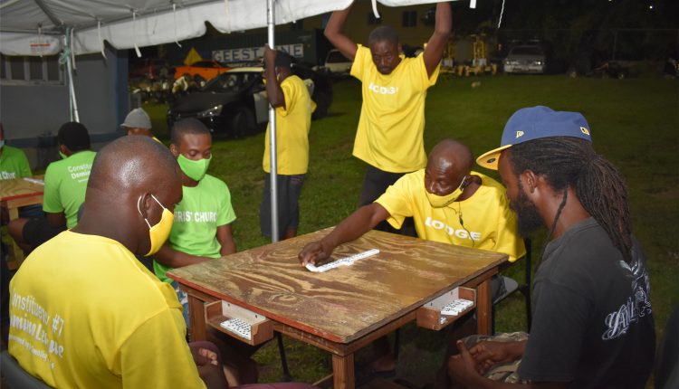 Taking no chances: O’Niel Thomas of Lodge Domino Club in action when his team met and beat Christ Church Domino Club 14-5 in the game played on the grounds of the Tabernacle Police Station.