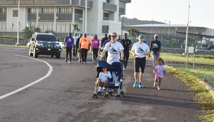 Prime Minister Dr the Hon Timothy Harris, Minister of Health the Hon Akilah Byron-Nisbett, and Mr Alexis Nisbett in the group seen walking past the Eastern Caribbean Central Bank.