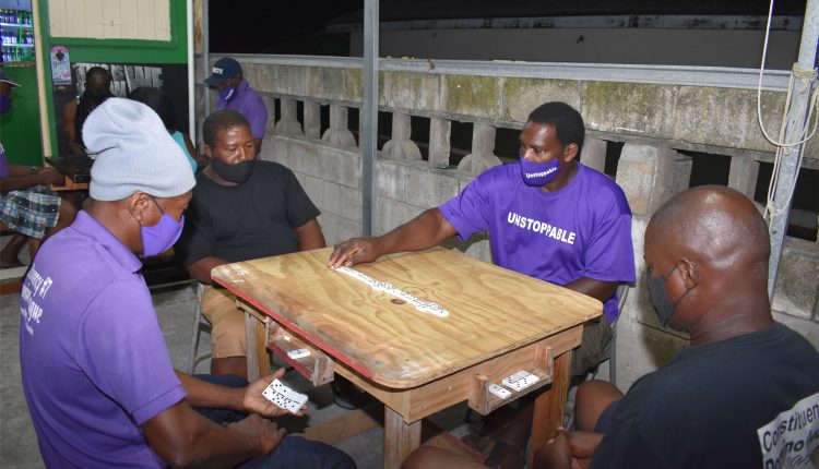 Taking care of the drink: Playing at Cuban Bar in Lodge Project, Lesroy Benjamin of Unstoppable Domino Club in action as his team dispatched Guinness Domino Club with a 13-8 beating