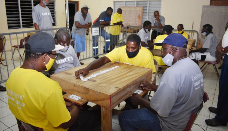 Jermaine James of Lodge Domino Club makes a move on the domino table when they met and beat Unity Domino Club 14-10 at the Lodge Community Centre on Tuesday October 6.