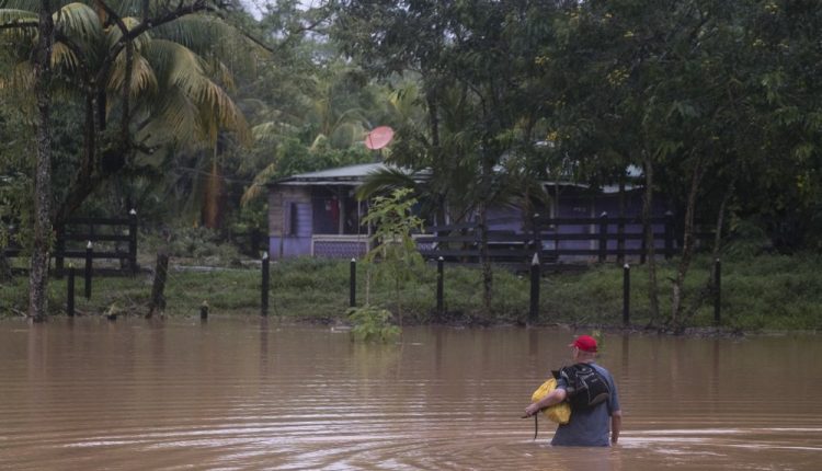 A man walks through a flooded road in Okonwas, Nicaragua, Wednesday, Nov. 4, 2020. Eta weakened from the Category 4 hurricane to a tropical storm after lashing Nicaragua’s Caribbean coast for much of Tuesday, its floodwaters isolating already remote communities and setting off deadly landslides. (AP Photo/Carlos Herrera)