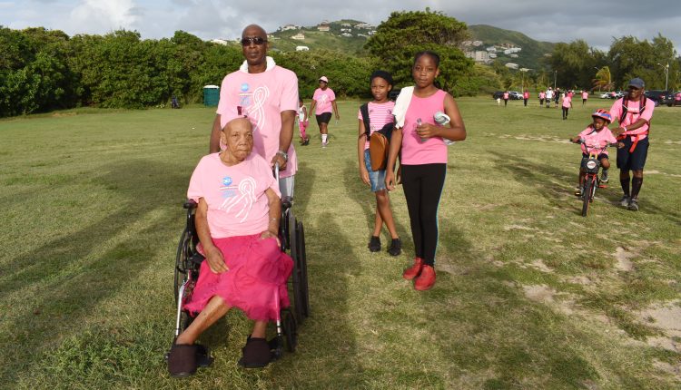 Arriving at the Frigate Bay lawns is wheelchair-bound 79-year-old Mrs Sylvia Duggins, with her son Mr Vincent Fough, and two granddaughters.