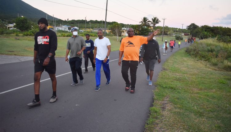 Prime Minister Dr the Hon Timothy Harris (wearing a SKN Moves T-shirt) seen walking along the Island Main Road in Tabernacle during the Prime Minister’s Health Walk on Saturday.