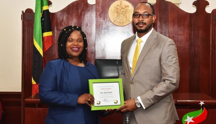 Speaker Of The SKNYPA, Hon. Patrice Harris, Presents Hon. Jonel Powell With His Certificate Of Induction Into The  SKNYPA