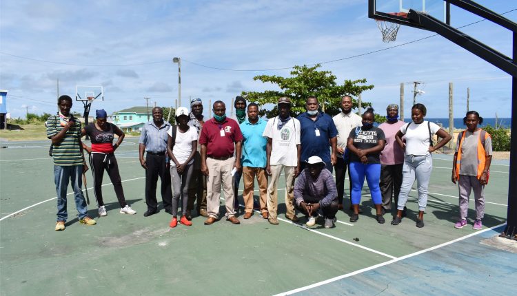 STEP Director Mr Emile Greene (6th right standing), accompanied by senior STEP field officers, pictured with members of the Keys STEP Community Enhancement Group. Supervisor Mrs Eudora Thompson-Herlle is on the right.
