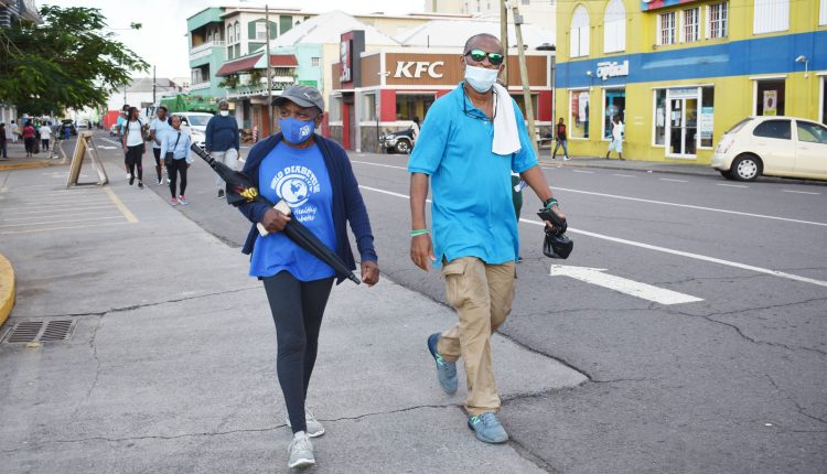 President of the St. Kitts Diabetes Association, Nurse Christine Wattley, and the Association’s PRO Dr Reginald O’Loughlin seen walking on Bay Road in downtown Basseterre.