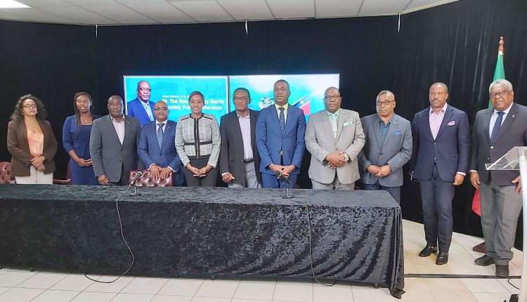 Prime Minister Harris (4th right) with members of Cabinet pictured along with Deputy Speaker Dr Bernicia Nisbett and Ambassador Ian Patches Liburd. Not in the picture is the Hon Eric Evelyn who was also at the press conference.