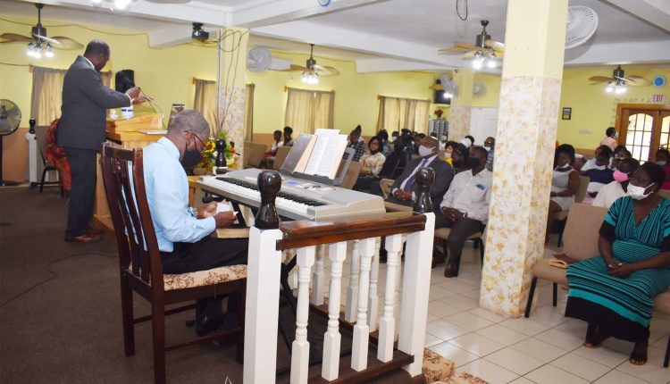 Pastor Roysdean Richards delivering the message at the Good News Baptist Church in Lime Kiln, West Basseterre. Prime Minister Dr the Hon Timothy Harris is seated on the front row, middle section.