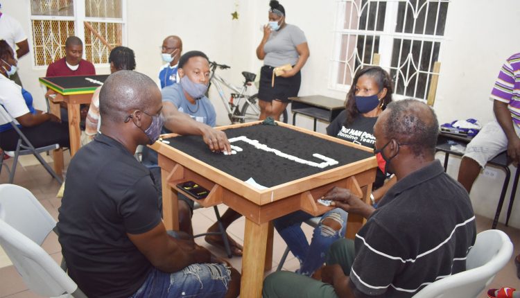 The Great Comeback: Kerell ‘Franks’ Dasent of Spartans Fig Tree Domino Club taking no chances when his team came back from behind to thrash Poor Man Pocket Domino Club 26-8.
