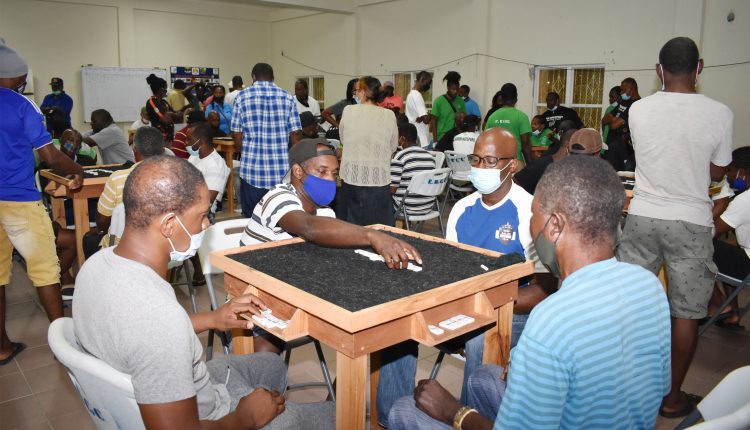 Taking no chances: Mervin Collins of Lodge Domino Club makes a move as his team met and beat King Balang Domino Club 28-10 on January 31 at the New Town Community Centre.