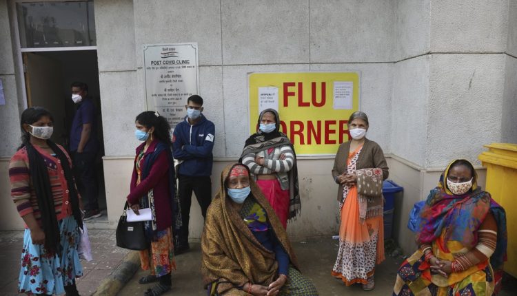 People wait outside a health center to get tested for COVID-19 in New Delhi, India, Thursday, Feb. 11, 2021. When the coronavirus pandemic took hold in India, there were fears it would sink the fragile health system of the world’s second-most populous country. Infections climbed dramatically for months and at one point India looked like it might overtake the United States as the country with the highest case toll. But infections began to plummet in September, and experts aren’t sure why. (AP Photo/Manish Swarup)