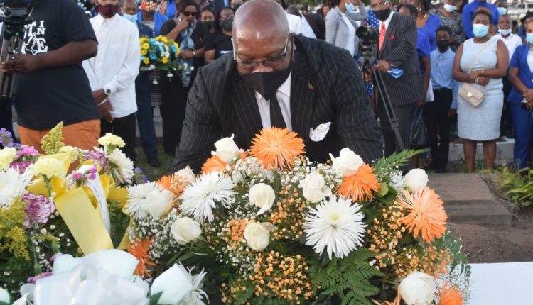 Prime Minister Dr. the Hon. Timothy Harris lays wreath at the final resting place of the late Apostle Dr. Allen Isaac.