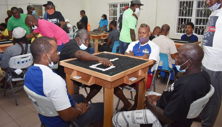 Raiding king’s barns: Antonio ‘Marsh’ Phillip of Poor Man Pocket (hand on the board) was not afraid of King Balang (to his left) as his team went on to down King Balang Domino Club 26-8.