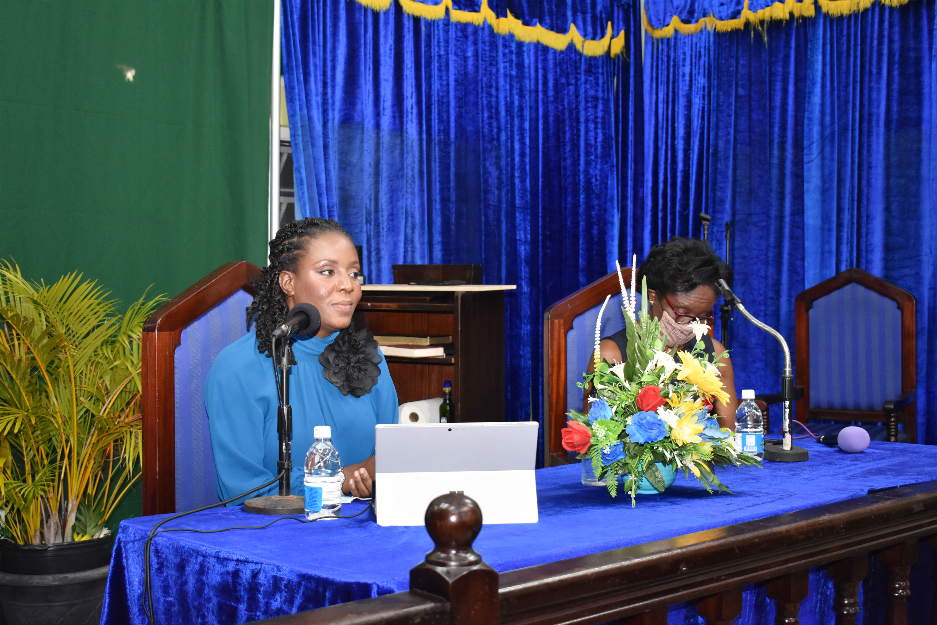 General Surgeon Dr Natalie Osborne addressing participants at a Covid-19 vaccination information session held at the Cayon Church of God. On the left (partly hidden) is chairperson of the session, Mrs Rosel Pemberton.