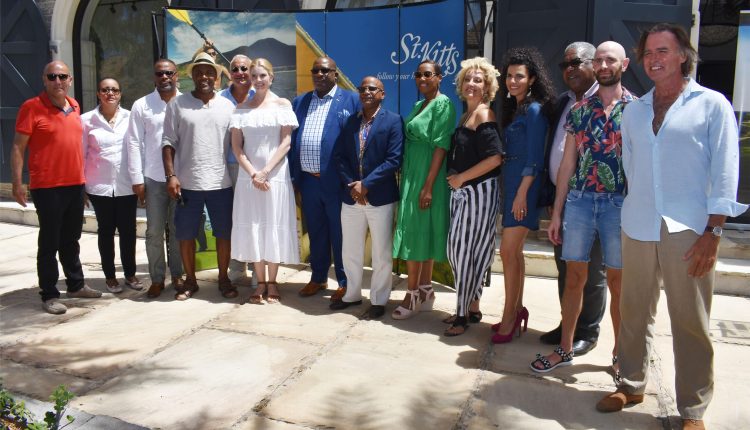 Prime Minister Harris (7th from left), members of Cabinet, and Producer of MSR Production, Mr Philippe Martinez (5th from left) pictured with some of the ‘One Year OFF’ cast members at Christophe Harbour.
