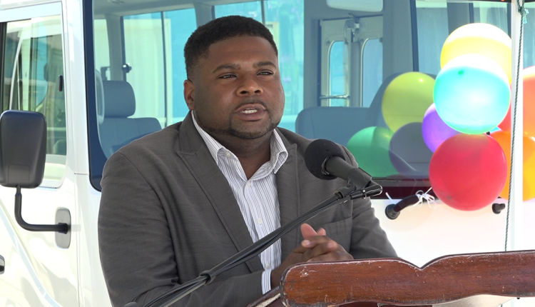 Hon. Troy Liburd, Junior Minister of Education in the Nevis Island Administration delivering remarks at a handing over ceremony for two new school buses to the Ministry of Education in Nevis on March 09, 2021