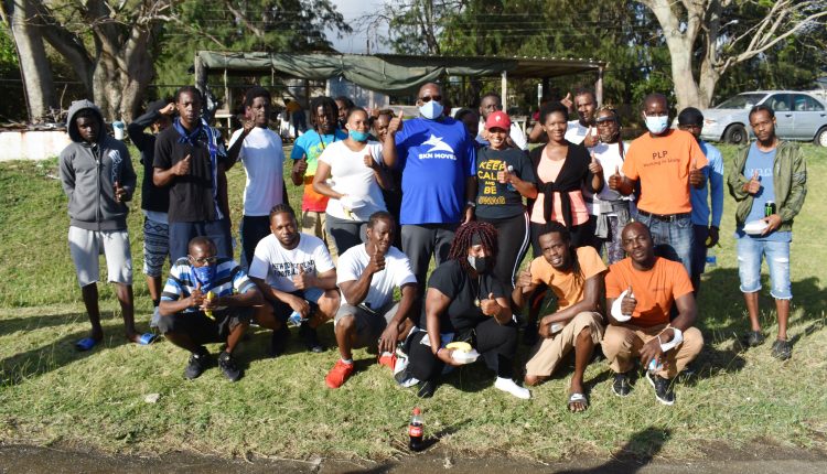 Prime Minister Harris (centre wearing blue SKN Moves shirt) is pictured with the group form St. Paul’s who were led by Mr Shaheed Williams (squatting right) at the Ottley’s hardcourts.