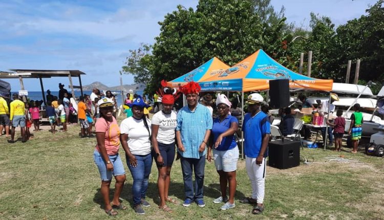 Hon. Eric Evelyn (centre) participates in the Department of Youth Beach Games at Oualie, Nevis on April 05, 2021