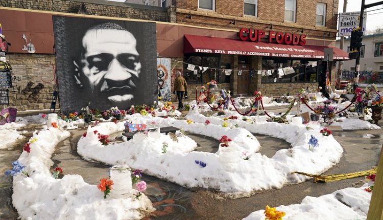 FILE – In this Feb. 8, 2021 file photo, A mural of George Floyd is seen in George Floyd Square in Minneapolis. The city of Minneapolis on Friday, March, 12, 2021, agreed to pay $27 million to settle a civil lawsuit from George Floyd’s family over the Black man’s death in police custody, as jury selection continued in a former officer’s murder trial. The settlement includes $500,000 for the south Minneapolis neighborhood that includes the 38th and Chicago intersection that has been blocked by barricades since his death, with a massive metal sculpture and murals in his honor. (AP Photo/Jim Mone File)