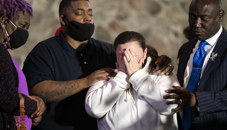 Katie Wright, mother of the deceased Daunte Wright, center, is comforted by her husband Aubrey, second from left