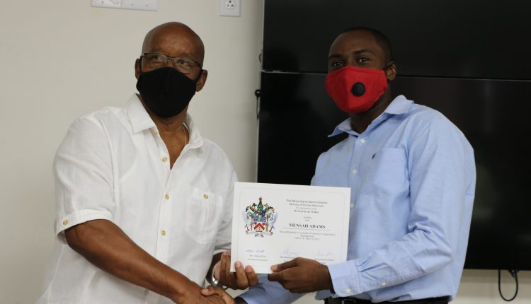 (l-r) Course facilitator Mr. Pearlievan Wilkin, educator and former senior civil servant, distributes certificates at the completion of a Supervisory Management Training Course on April 19, 2021